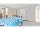 Bedroom with light gray walls, carpet and adjacent doors to bathroom and hallway at 218 Woodruff Way, Peachtree City, GA 30269