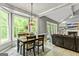 Bright dining area with large windows and adjacent living space at 218 Woodruff Way, Peachtree City, GA 30269