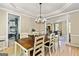 Open-concept dining room with hardwood floors, view of staircase and kitchen at 218 Woodruff Way, Peachtree City, GA 30269