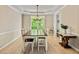 Bright dining room with hardwood floors, large window and a wooden table with seating for eight at 218 Woodruff Way, Peachtree City, GA 30269