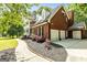Stunning brick home with a three-car garage, manicured landscaping, and a charming front porch with white columns at 218 Woodruff Way, Peachtree City, GA 30269