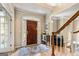 Elegant foyer with hardwood floors, staircase, and a view into the living room, creating a welcoming ambiance at 218 Woodruff Way, Peachtree City, GA 30269