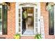 Inviting front entrance with a wreath, welcome sign, and sidelights, showcasing a glimpse of the bright foyer at 218 Woodruff Way, Peachtree City, GA 30269