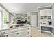 Open kitchen showcasing a cooktop island, dining area, and seamless flow to the living room at 218 Woodruff Way, Peachtree City, GA 30269