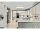 Bright kitchen with white cabinets, stainless steel appliances, and a spacious island at 218 Woodruff Way, Peachtree City, GA 30269