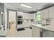 Well-lit kitchen featuring white cabinets, stainless steel appliances, and a dining area at 218 Woodruff Way, Peachtree City, GA 30269