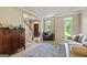 Inviting living area featuring hardwood floors, staircase and open access to the front door at 218 Woodruff Way, Peachtree City, GA 30269