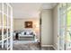 Inviting living room with French doors, a comfortable sofa, and tasteful decor, creating a cozy atmosphere at 218 Woodruff Way, Peachtree City, GA 30269