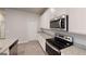 Modern kitchen featuring stainless steel appliances, granite countertops, and ample white cabinetry at 3 Roving Hills Cir, Cartersville, GA 30121