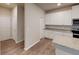 Bright kitchen showcasing white cabinetry, stainless steel appliances, and granite countertops at 3 Roving Hills Cir, Cartersville, GA 30121