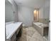 Bright bathroom featuring a soaking tub, ceramic tiled floor, and double vanity at 105 Old Hickory Pointe, Mcdonough, GA 30252