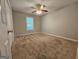 Neutral bedroom with carpeted floor, ceiling fan, and double door closet at 105 Old Hickory Pointe, Mcdonough, GA 30252