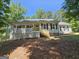 Inviting home exterior boasting a spacious porch with wooden railings, perfect for relaxing outdoors at 105 Old Hickory Pointe, Mcdonough, GA 30252