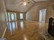 Open living room featuring wood floors and a white front door with sidelights at 105 Old Hickory Pointe, Mcdonough, GA 30252