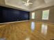 Spacious main bedroom with wood floors, a tray ceiling, and natural light from the windows at 105 Old Hickory Pointe, Mcdonough, GA 30252