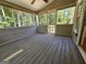 A screened-in porch with wood decking at 105 Old Hickory Pointe, Mcdonough, GA 30252