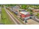 Aerial view of commercial building and railroad tracks with a vintage Coca-Cola advertisement painted on the building at 1128 Milstead Ne Ave, Conyers, GA 30012