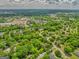 Expansive aerial view of the property, surrounded by mature trees and picturesque neighborhood streets at 1128 Milstead Ne Ave, Conyers, GA 30012