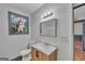 Bathroom features a marble countertop vanity, stylish mirror, and window with natural light at 1128 Milstead Ne Ave, Conyers, GA 30012