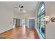 Large bedroom featuring hardwood floors, a ceiling fan, two closets, and a statement arched window at 1128 Milstead Ne Ave, Conyers, GA 30012