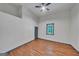 Bright bedroom has a ceiling fan and natural light through a large window overlooking trees at 1128 Milstead Ne Ave, Conyers, GA 30012