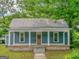 Charming single-story home with a welcoming front porch and a classic metal roof at 1128 Milstead Ne Ave, Conyers, GA 30012