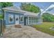 Exterior view showcasing the home's entrance, patio and enclosed porch, highlighting architectural features and access at 1128 Milstead Ne Ave, Conyers, GA 30012