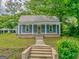 Charming home featuring a classic porch with elegant columns, offering a welcoming curb appeal and timeless design at 1128 Milstead Ne Ave, Conyers, GA 30012