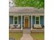 Inviting front porch featuring a seating area with a stylish blue exterior and matching furniture at 1128 Milstead Ne Ave, Conyers, GA 30012