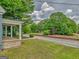 Inviting front yard showcasing lush greenery and a charming porch with classic columns, perfect for relaxing at 1128 Milstead Ne Ave, Conyers, GA 30012