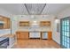 Eat-in kitchen features wood floors, modern lighting, and wooden cabinetry at 1128 Milstead Ne Ave, Conyers, GA 30012