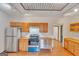 Eat-in kitchen with stainless steel appliances, modern track lighting, and wood flooring at 1128 Milstead Ne Ave, Conyers, GA 30012