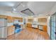 Eat-in kitchen features stainless steel appliances, blue accents, and wood flooring at 1128 Milstead Ne Ave, Conyers, GA 30012