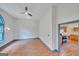 Bright living room features wood flooring, natural light and an open doorway to the kitchen at 1128 Milstead Ne Ave, Conyers, GA 30012