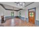 Bright living room with original stained glass door, trim work, and hardwood floors at 1128 Milstead Ne Ave, Conyers, GA 30012