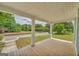 Long front porch with white columns and wooden floor offer a place to sit outside at 1128 Milstead Ne Ave, Conyers, GA 30012