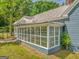 View of an enclosed porch with multiple windows providing lots of natural light and greenery at 1128 Milstead Ne Ave, Conyers, GA 30012