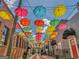 Charming street view featuring colorful umbrellas suspended above a pedestrian-friendly zone, brick buildings and bike racks at 1128 Milstead Ne Ave, Conyers, GA 30012
