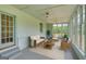 Bright sunroom with wicker furniture, lots of light and neutral decor at 1128 Milstead Ne Ave, Conyers, GA 30012