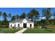 New clubhouse with an open lawn and playground sits on a sunny day at 2358 Argento Cir, Dacula, GA 30019
