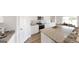 Open kitchen features a large island with granite countertops, stainless appliances, and white cabinets at 2358 Argento Cir, Dacula, GA 30019