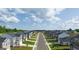 New homes line a street with sidewalks and landscaping under a blue sky with clouds at 560 Whitman Ln # 2016, Stockbridge, GA 30281