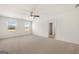Spacious bedroom with carpet flooring, ceiling fan, and natural light from the two windows at 560 Whitman Ln # 2016, Stockbridge, GA 30281