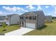 Two-story home boasts a brick facade, gray siding, attached garage, and a well-manicured lawn at 560 Whitman Ln # 2016, Stockbridge, GA 30281
