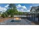 Outdoor fire pit and seating area near the pool, with a glimpse of the community amenities at 560 Whitman Ln # 2016, Stockbridge, GA 30281