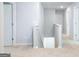 Upstairs hallway with carpet, white walls, and doors leading to various rooms at 560 Whitman Ln # 2016, Stockbridge, GA 30281