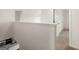 Upstairs hallway with railing and view of kitchen below and doors to different rooms at 560 Whitman Ln # 2016, Stockbridge, GA 30281