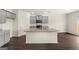 Eat-in kitchen with grey cabinets, granite countertops, a large island, and stainless steel appliances at 560 Whitman Ln # 2016, Stockbridge, GA 30281