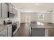 Kitchen with gray cabinets, granite countertops, stainless appliances, and dark wood floors at 560 Whitman Ln # 2016, Stockbridge, GA 30281