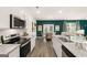 Well-appointed kitchen with stainless steel appliances, granite counters, and open layout to dining and living spaces at 560 Whitman Ln # 2016, Stockbridge, GA 30281